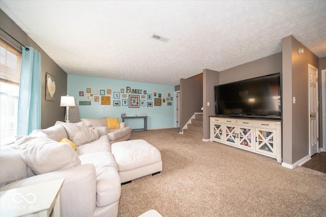 carpeted living room with a textured ceiling