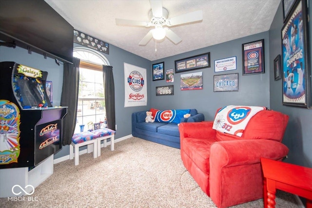 game room with ceiling fan, carpet flooring, and a textured ceiling