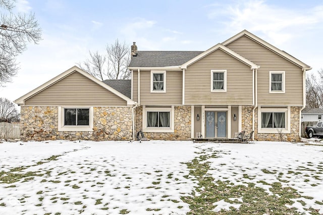 view of snow covered rear of property