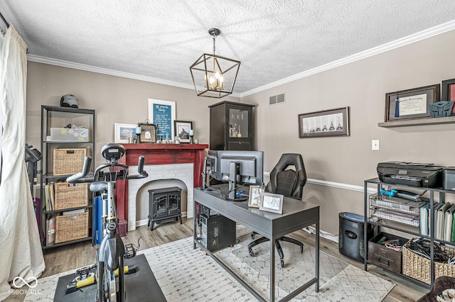 office space featuring ornamental molding, a textured ceiling, and light hardwood / wood-style flooring