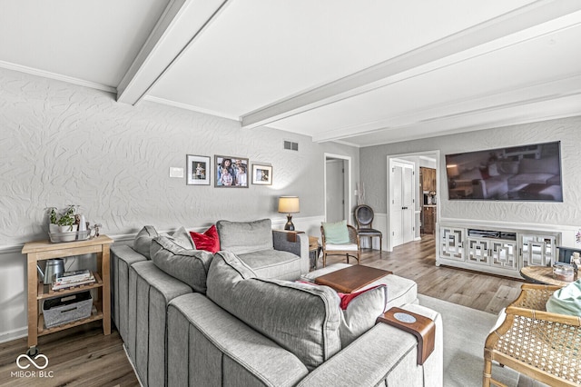 living room with wood-type flooring and beam ceiling