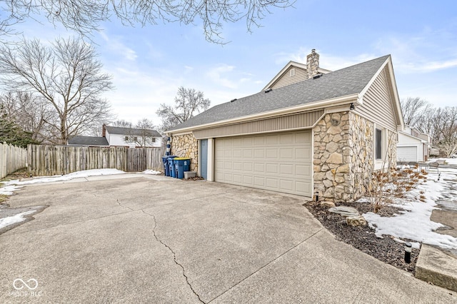 view of snow covered exterior featuring a garage