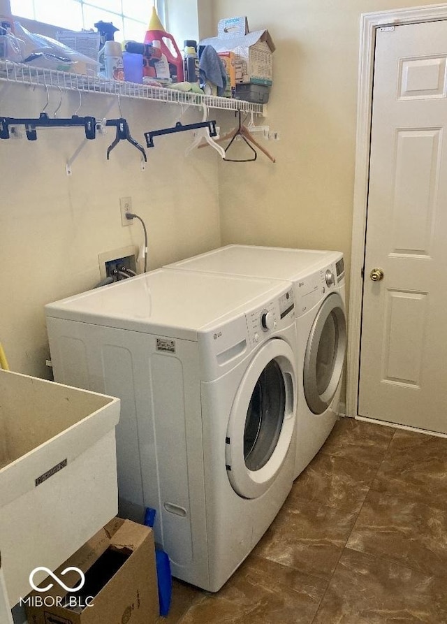 clothes washing area with sink and independent washer and dryer