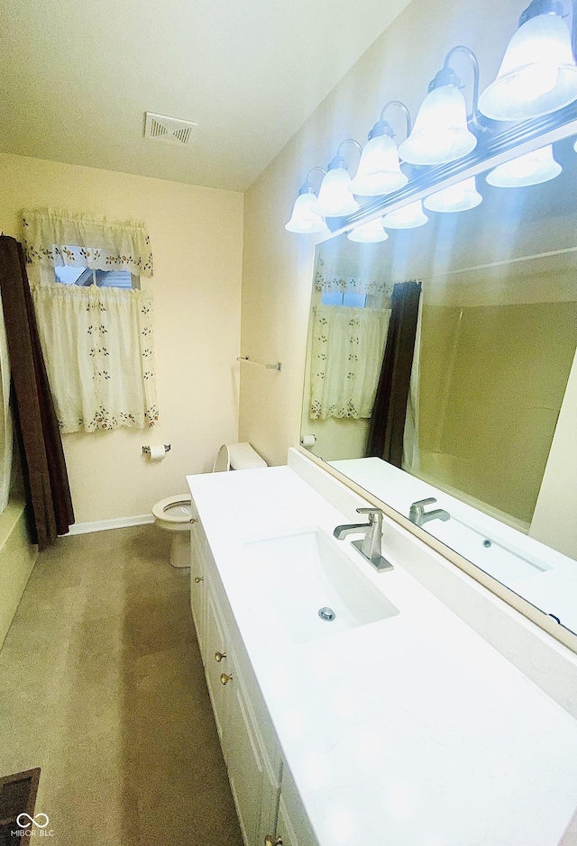 bathroom featuring vanity and toilet