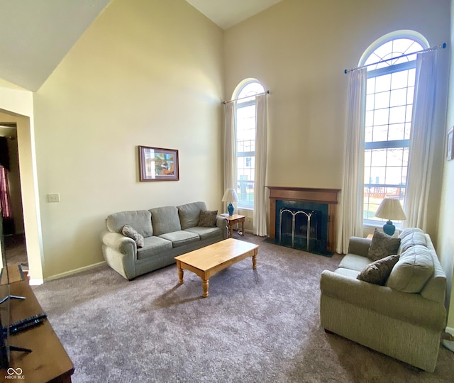 carpeted living room with high vaulted ceiling and a wealth of natural light