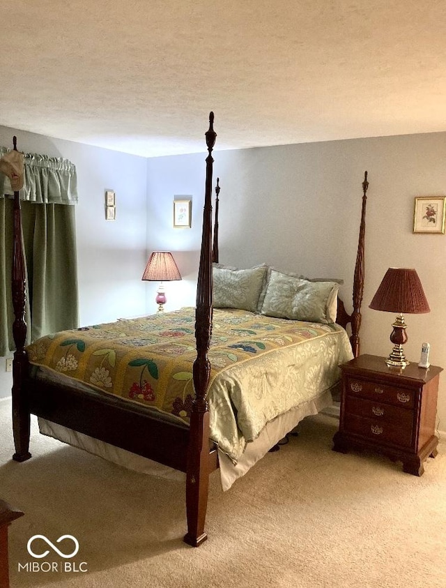 carpeted bedroom featuring a textured ceiling