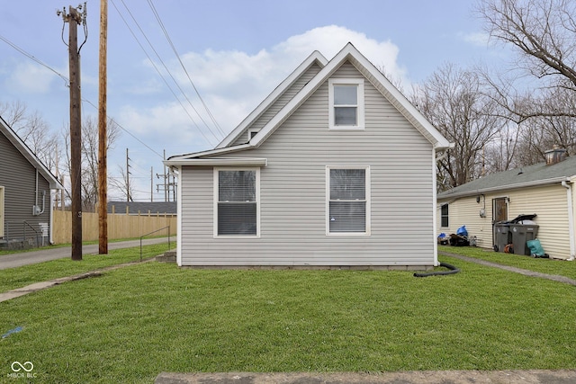 view of side of home with a yard