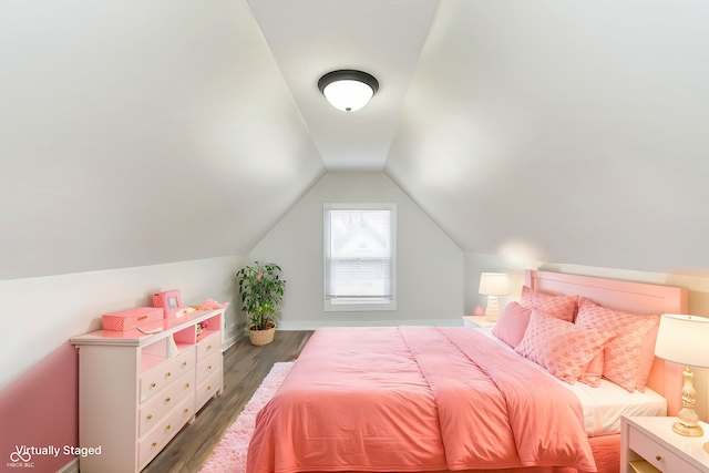 bedroom with vaulted ceiling and dark wood-type flooring