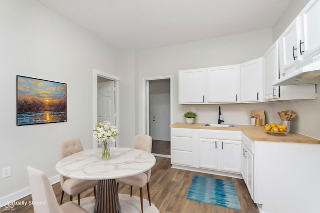 kitchen featuring dark hardwood / wood-style floors, sink, and white cabinets