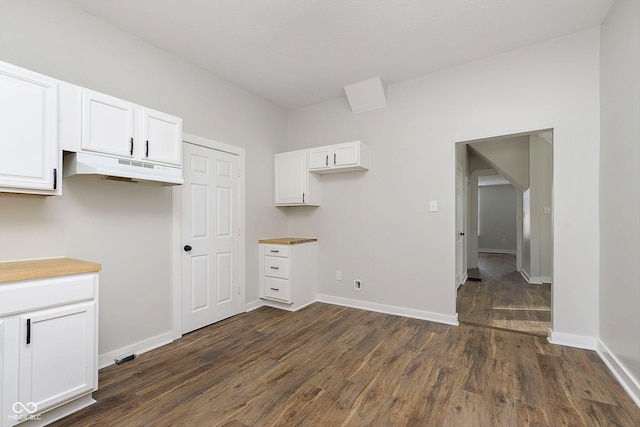 kitchen with dark wood-type flooring and white cabinets