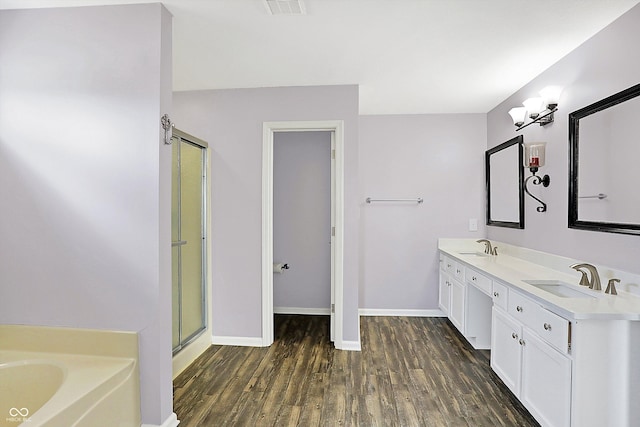 bathroom featuring vanity, shower with separate bathtub, and hardwood / wood-style floors