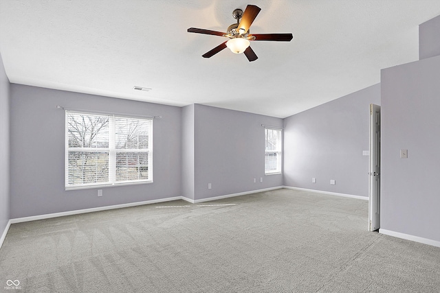 carpeted empty room with ceiling fan and a textured ceiling