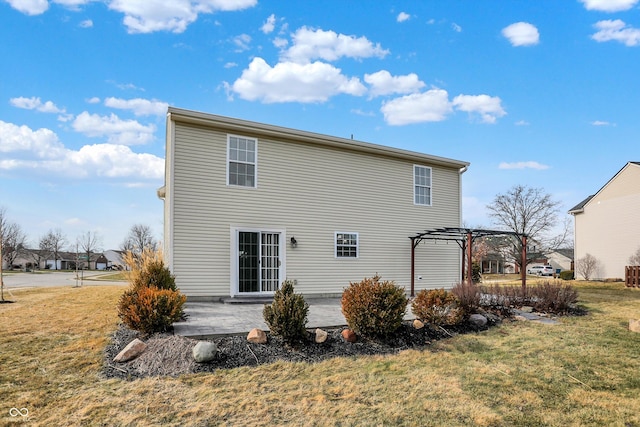 back of house with a pergola, a patio area, and a lawn