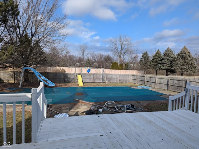 view of swimming pool with a deck and a water slide