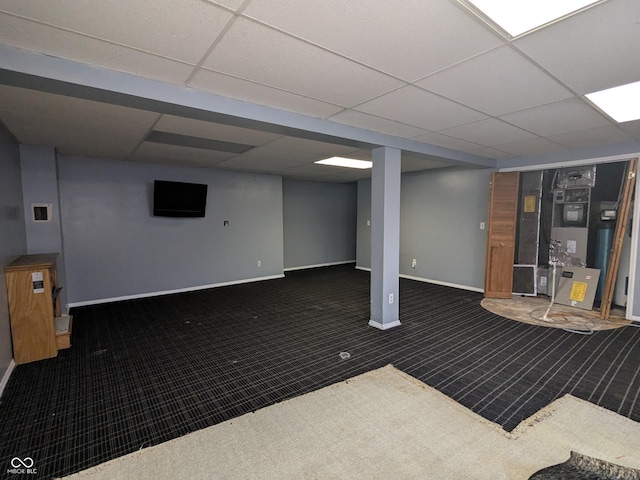 basement with dark carpet and a drop ceiling