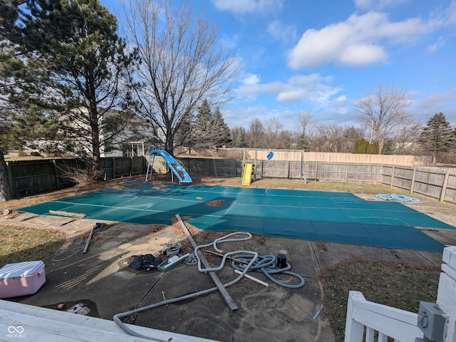 view of swimming pool with a water slide