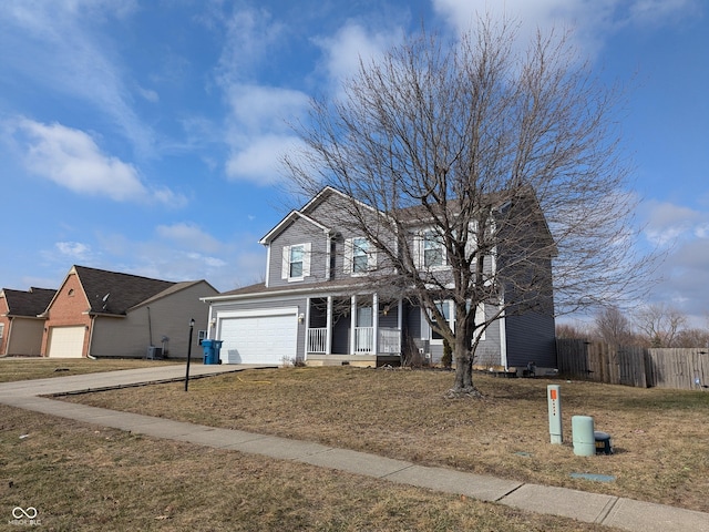 front of property with a porch, a garage, and a front lawn