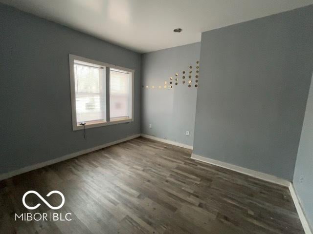 unfurnished room featuring dark hardwood / wood-style flooring