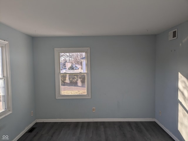 unfurnished room with dark hardwood / wood-style floors