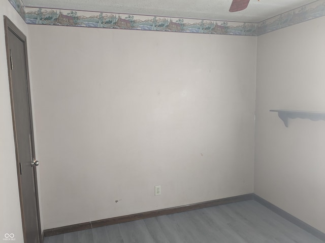 spare room featuring a textured ceiling, light hardwood / wood-style floors, and ceiling fan