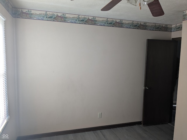 empty room featuring ceiling fan, hardwood / wood-style floors, and a textured ceiling