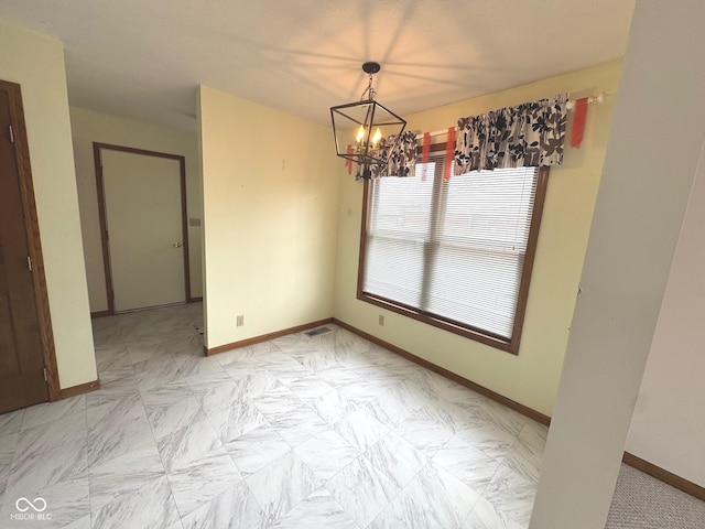 unfurnished dining area featuring an inviting chandelier