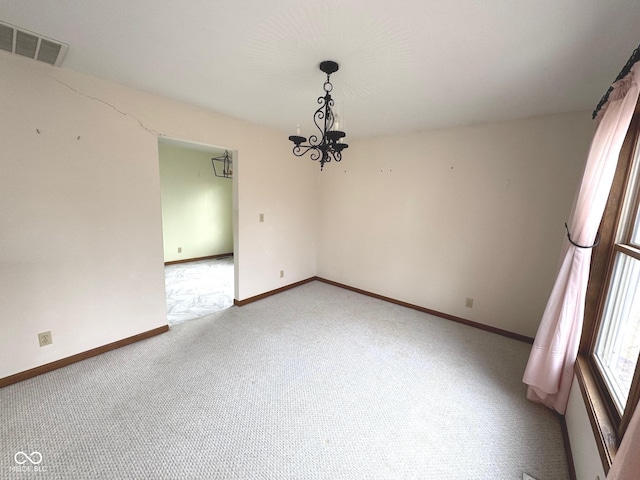 unfurnished dining area featuring carpet and an inviting chandelier