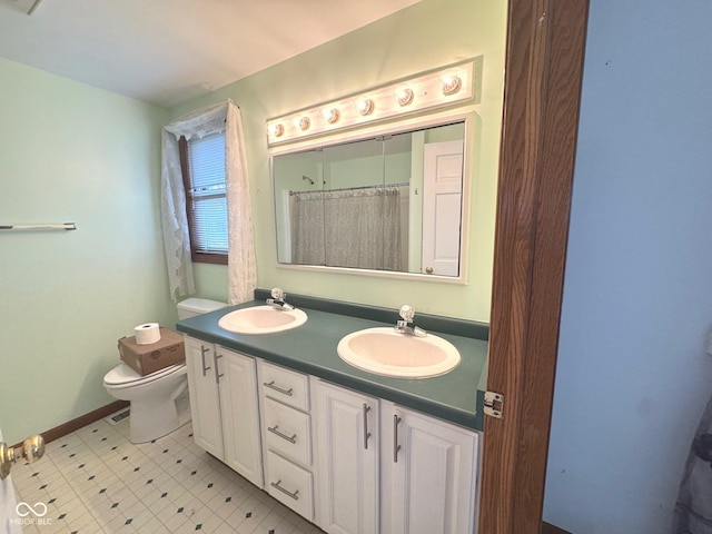 bathroom featuring vanity and toilet