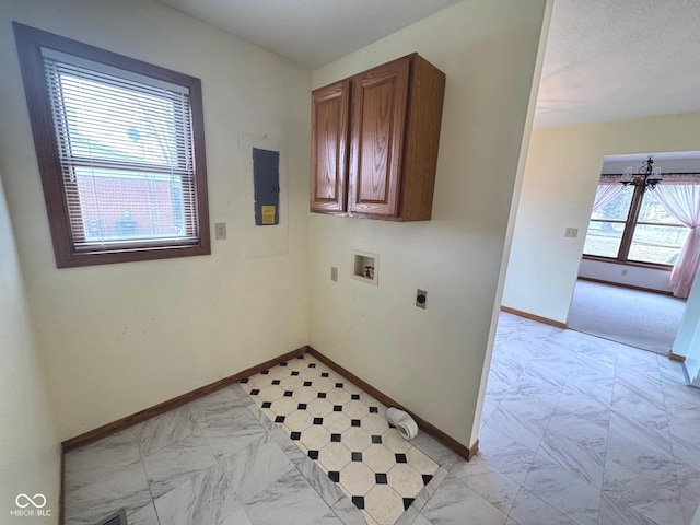 washroom with electric dryer hookup, electric panel, cabinets, washer hookup, and a chandelier