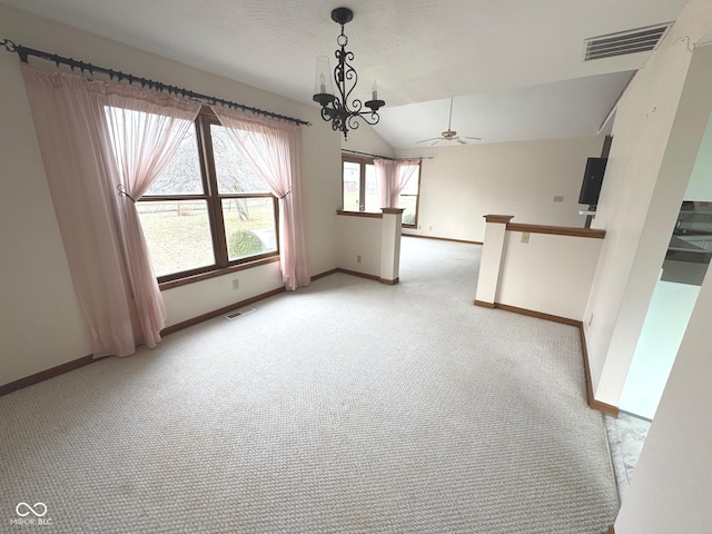 unfurnished room featuring light carpet, ceiling fan with notable chandelier, and vaulted ceiling