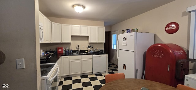 kitchen featuring sink, white appliances, and white cabinets