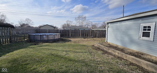 view of yard with a fenced in pool