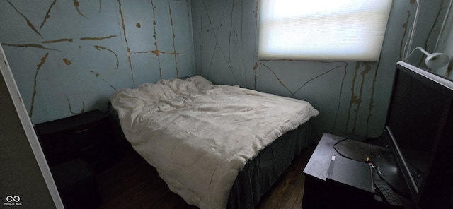 bedroom with dark hardwood / wood-style floors