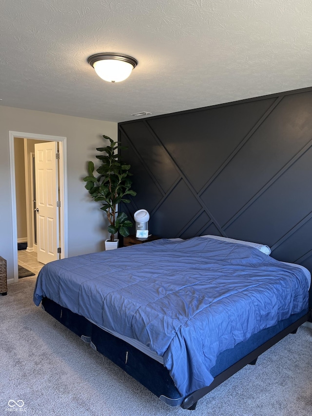 carpeted bedroom with a textured ceiling