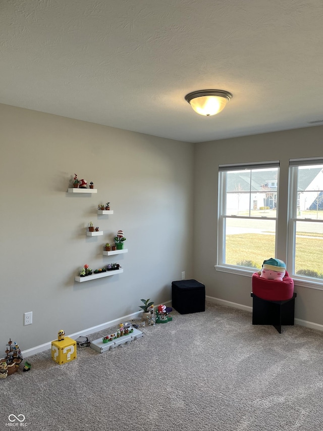 interior space with a textured ceiling, a healthy amount of sunlight, and carpet