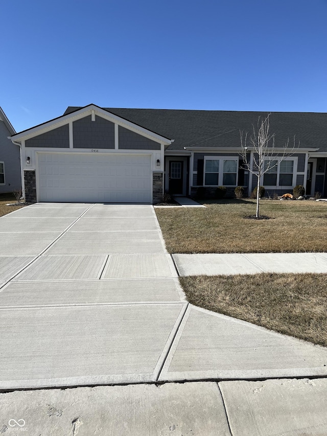 ranch-style home featuring a garage and a front yard