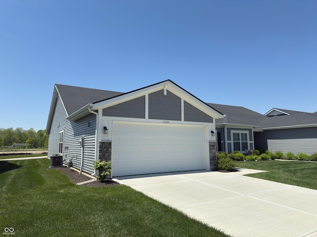 19438 Astoria Ave, Sheridan, IN 46069 - view of front of house featuring stone siding, an attached garage, cooling unit, and a front lawn