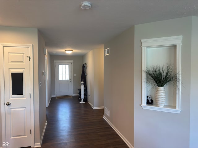 19438 Astoria Ave, Sheridan, IN 46069 - doorway with baseboards and dark wood-type flooring