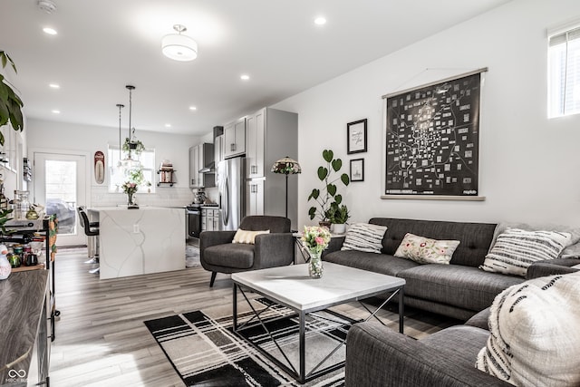 living room with plenty of natural light and light wood-type flooring