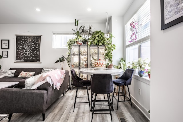 dining space with wood-type flooring