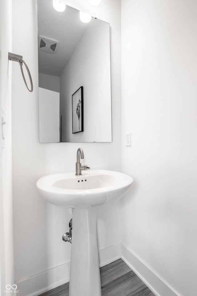 bathroom with hardwood / wood-style floors