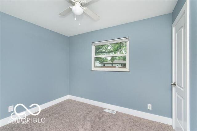 spare room with ceiling fan and carpet