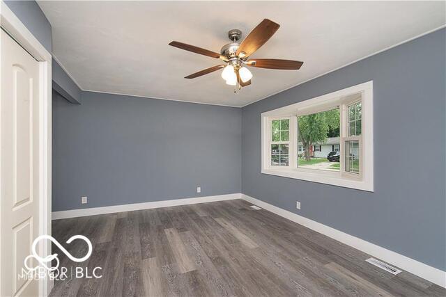 unfurnished bedroom featuring dark hardwood / wood-style floors and ceiling fan