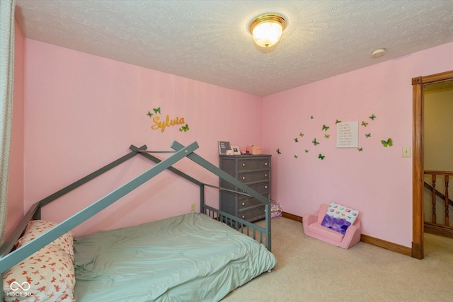 carpeted bedroom featuring a textured ceiling