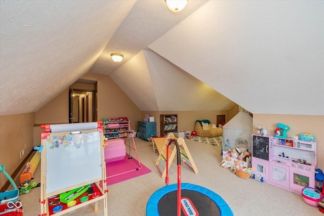 recreation room featuring lofted ceiling, a textured ceiling, and carpet