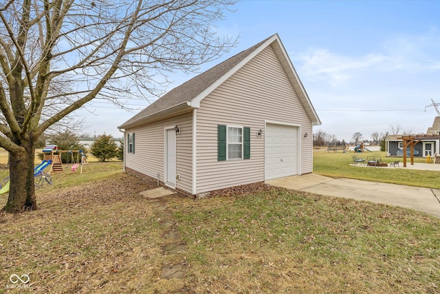 view of side of property with a playground, an outdoor structure, a yard, and a garage