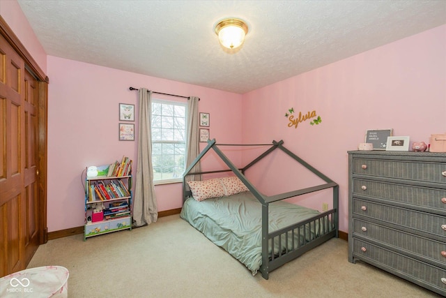 bedroom with carpet floors and a textured ceiling