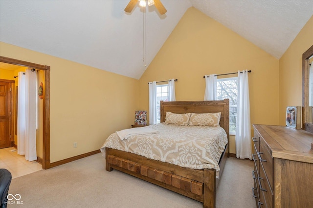 carpeted bedroom with ceiling fan and high vaulted ceiling