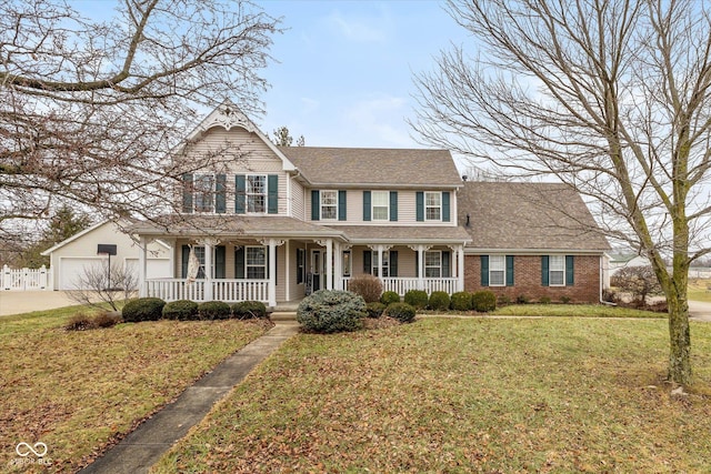 view of front facade featuring a garage, a front yard, and covered porch