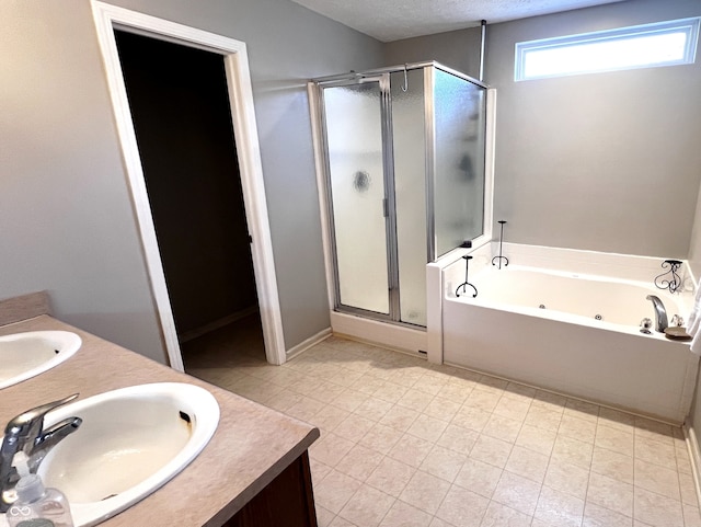 bathroom featuring vanity, shower with separate bathtub, and a textured ceiling